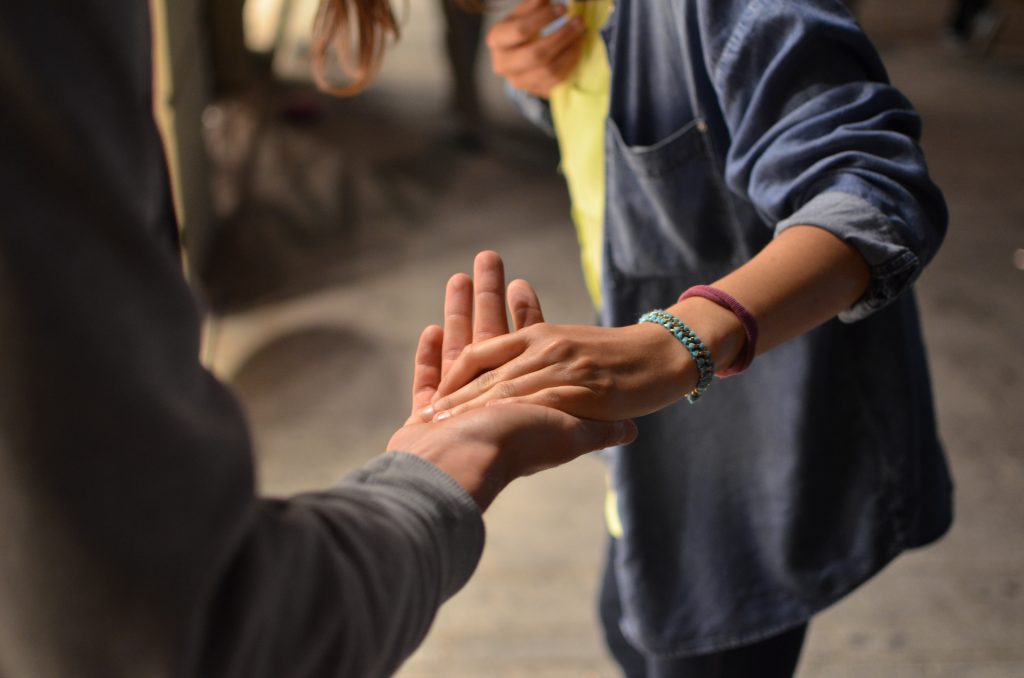 Person reaching out hand to someone else