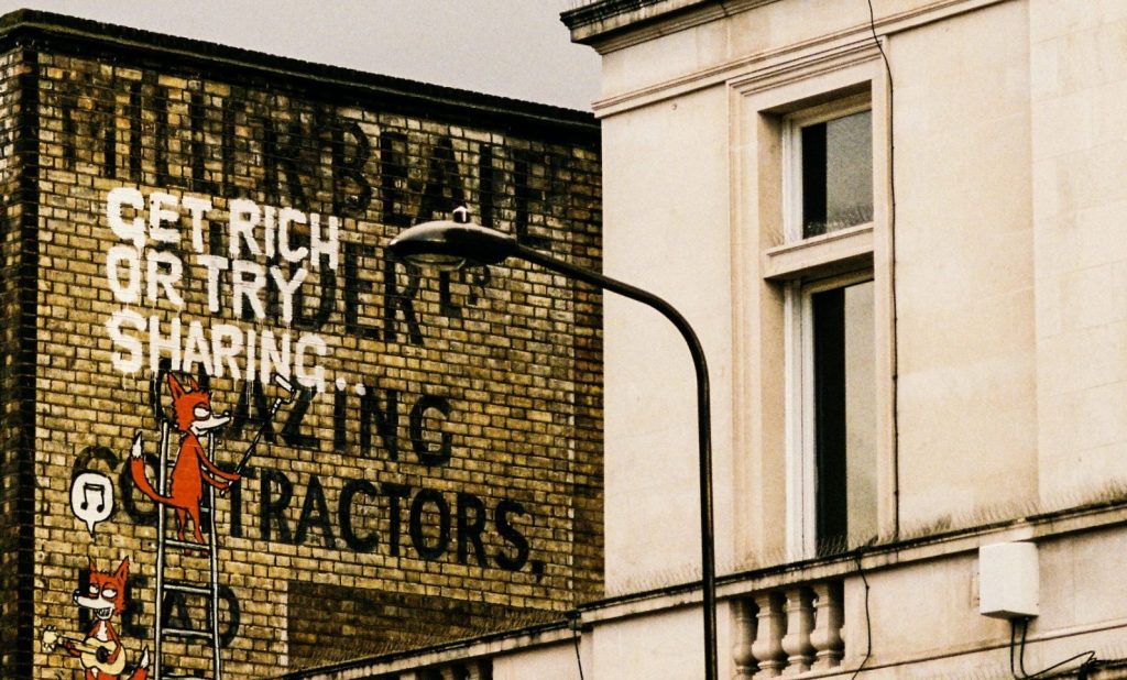 Image of get rich or try sharing street art